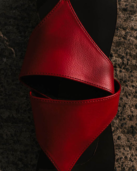 Red sandal on a textured surface